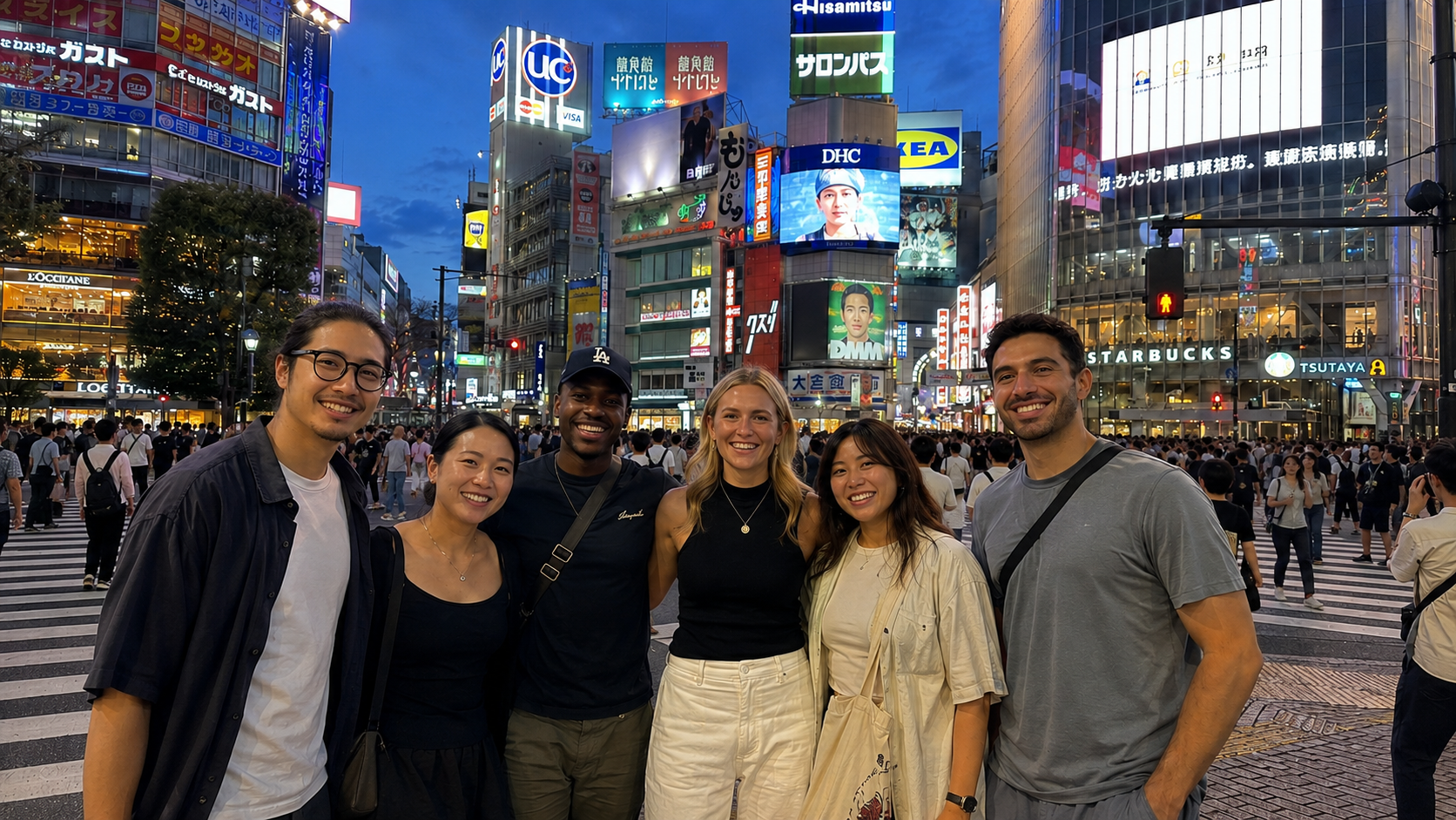 A group of friends together at Shibuya Crossing in Tokyo at dusk